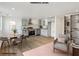 This staged living room features a dining nook and kitchen with stainless steel appliances at 3939 Hamilton Mill Rd, Buford, GA 30519