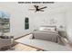 Bright main bedroom featuring a ceiling fan, two windows, and modern decor at 3939 Hamilton Mill Rd, Buford, GA 30519