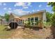 A private backyard features a stone patio, grill, and lush green landscaping at 4535 Vanadium Bnd, Cumming, GA 30040