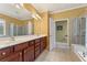 Elegant bathroom featuring double sinks, a walk-in shower, and a soaking tub at 4535 Vanadium Bnd, Cumming, GA 30040