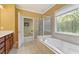 Bright bathroom with a soaking tub, walk-in shower, and custom vanity with ample storage at 4535 Vanadium Bnd, Cumming, GA 30040