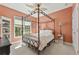 Bedroom features peach walls, carpet, and an iron canopy bed at 4535 Vanadium Bnd, Cumming, GA 30040