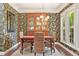 Dining room features tropical wallpaper, hardwood floors, and a hutch at 4535 Vanadium Bnd, Cumming, GA 30040