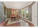 Dining room features tropical wallpaper, hardwood floors, and a hutch at 4535 Vanadium Bnd, Cumming, GA 30040