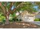 Single-Gathering home with a two-car garage, showcases mature trees, attractive landscaping, and manicured lawn at 4535 Vanadium Bnd, Cumming, GA 30040