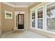Welcoming front porch showcasing the entry door with sidelights, offering a glimpse of the home's charming interior at 4535 Vanadium Bnd, Cumming, GA 30040