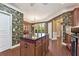 Kitchen with hardwood floors, tropical wallpaper, and a center island at 4535 Vanadium Bnd, Cumming, GA 30040