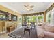 Sunroom filled with light offers casual seating and a decorative rug at 4535 Vanadium Bnd, Cumming, GA 30040