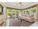 Bright sunroom featuring a cozy seating area, large windows, and stylish animal print rug at 4535 Vanadium Bnd, Cumming, GA 30040
