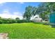 Large grass-covered backyard with trees in the background on a sunny day at 5150 Wheat Ne St, Covington, GA 30014