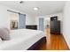 Bright bedroom features wood floors, barn door to walk-in closet, and updated dressers at 5150 Wheat Ne St, Covington, GA 30014