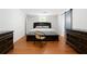 Serene bedroom with hardwood floors, a blue sliding barn door, and modern furnishings at 5150 Wheat Ne St, Covington, GA 30014
