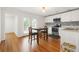 Bright kitchen with a dining area featuring white cabinets, stainless steel appliances and modern backsplash at 5150 Wheat Ne St, Covington, GA 30014