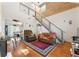 The living room features a soaring ceiling, unique staircase, wood wall accents and hardwood floors at 5150 Wheat Ne St, Covington, GA 30014