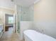 Bathroom featuring a soaking tub, glass shower, and modern tile at 1965 Nocturne Dr # 1306A, Alpharetta, GA 30009