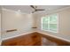A well-lit bedroom featuring hardwood floors, neutral paint, a ceiling fan, and natural light from a window at 1965 Nocturne Dr # 1306A, Alpharetta, GA 30009