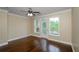 Bedroom with hardwood floors and a door to the balcony at 1965 Nocturne Dr # 1306A, Alpharetta, GA 30009