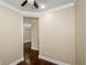 Bedroom with neutral paint, hardwood floors, and view to another room at 1965 Nocturne Dr # 1306A, Alpharetta, GA 30009