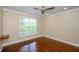 Bedroom with hardwood floors, a large window, and base molding at 1965 Nocturne Dr # 1306A, Alpharetta, GA 30009