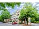 Condominium building with balconies, manicured landscaping, and parking at 1965 Nocturne Dr # 1306A, Alpharetta, GA 30009