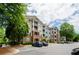 Apartment building with parking area and mature trees at 1965 Nocturne Dr # 1306A, Alpharetta, GA 30009