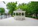 Scenic view of a white gazebo on a concrete pad, surrounded by green trees in the community at 1965 Nocturne Dr # 1306A, Alpharetta, GA 30009
