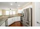 Well-equipped kitchen featuring stainless steel appliances, granite countertops, and white cabinetry at 1965 Nocturne Dr # 1306A, Alpharetta, GA 30009