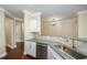 Open-concept kitchen with granite counters, stainless steel appliances, and tile backsplash at 1965 Nocturne Dr # 1306A, Alpharetta, GA 30009