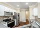 Modern kitchen features stainless steel appliances, granite counters, and white cabinets at 1965 Nocturne Dr # 1306A, Alpharetta, GA 30009