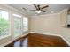 Bright living room with hardwood floors, ceiling fan, and access to a balcony with natural light at 1965 Nocturne Dr # 1306A, Alpharetta, GA 30009
