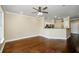 Spacious living room featuring hardwood floors and a ceiling fan, next to the open kitchen at 1965 Nocturne Dr # 1306A, Alpharetta, GA 30009