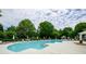 An in-ground community pool with lounge chairs and umbrellas and gazebo on the pool deck at 1965 Nocturne Dr # 1306A, Alpharetta, GA 30009
