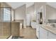Bathroom featuring a single sink vanity, glass-enclosed shower, and relaxing soaking tub at 502 Stoneland Pl, Lawrenceville, GA 30046