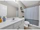 Bathroom featuring a single sink vanity, shower-tub, and decorative shelves at 502 Stoneland Pl, Lawrenceville, GA 30046