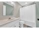 Bathroom featuring a single sink vanity, shower-tub, and modern decor at 502 Stoneland Pl, Lawrenceville, GA 30046