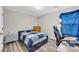 Well-lit bedroom featuring a dedicated desk area at 502 Stoneland Pl, Lawrenceville, GA 30046
