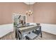 Spacious dining room with a dark wood table, room for a bench at 502 Stoneland Pl, Lawrenceville, GA 30046
