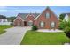 Charming brick home with manicured lawn and green shutters at 502 Stoneland Pl, Lawrenceville, GA 30046
