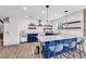 Modern kitchen with white subway tile, blue cabinets, and stylish pendant lighting at 502 Stoneland Pl, Lawrenceville, GA 30046