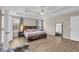 Main bedroom features wood-look flooring, large windows, and stylish wood furniture at 502 Stoneland Pl, Lawrenceville, GA 30046