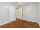 Bedroom with hardwood floors, light paint, two closets with white doors and a ceiling fan at 8185 Rivertown Rd, Fairburn, GA 30213
