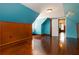 Bright bedroom with wood paneled accent walls, light, and gleaming hardwood floors at 8185 Rivertown Rd, Fairburn, GA 30213