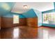 Bedroom with wood paneled lower walls, two windows and blue painted upper walls and ceiling at 8185 Rivertown Rd, Fairburn, GA 30213