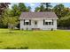 Welcoming single-Gathering home with a lush lawn, a driveway, and white siding that exudes a classic appeal at 8185 Rivertown Rd, Fairburn, GA 30213
