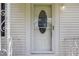Elegant front door with decorative glass detailing, offering a warm welcome and enhancing curb appeal at 8185 Rivertown Rd, Fairburn, GA 30213