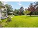 Well-maintained front yard with lush green grass and mature trees provides curb appeal at 8185 Rivertown Rd, Fairburn, GA 30213