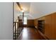 Hallway features hardwood floors, wood paneled walls, and natural light from the window at 8185 Rivertown Rd, Fairburn, GA 30213