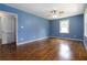 Spacious living room with wood floors, a ceiling fan, and a window, providing comfort and natural light at 8185 Rivertown Rd, Fairburn, GA 30213