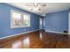 Bright living room features gleaming hardwood floors, fresh blue paint, and an inviting space at 8185 Rivertown Rd, Fairburn, GA 30213
