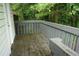 Back deck painted gray overlooks a wooded area, providing privacy and nature views at 936 Glynn Oaks Dr, Clarkston, GA 30021